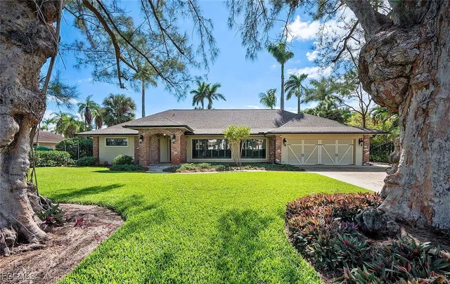 a front view of house with yard and outdoor seating