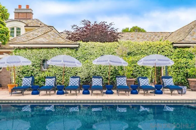 a view of a patio with chairs and potted plants