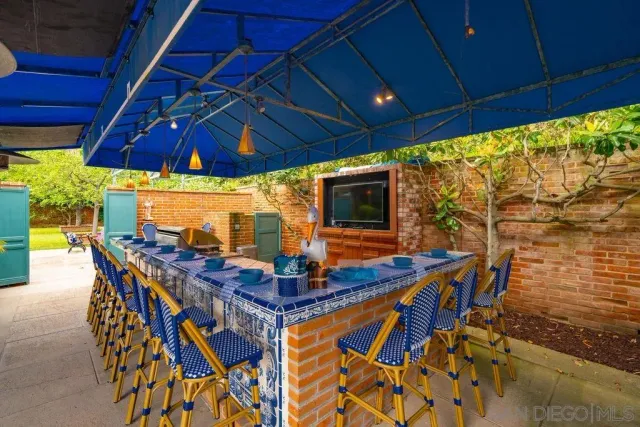 a living room with furniture a flat screen tv and a large window