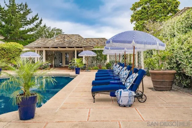 a kitchen with stainless steel appliances granite countertop a refrigerator a stove a microwave and a potted plant