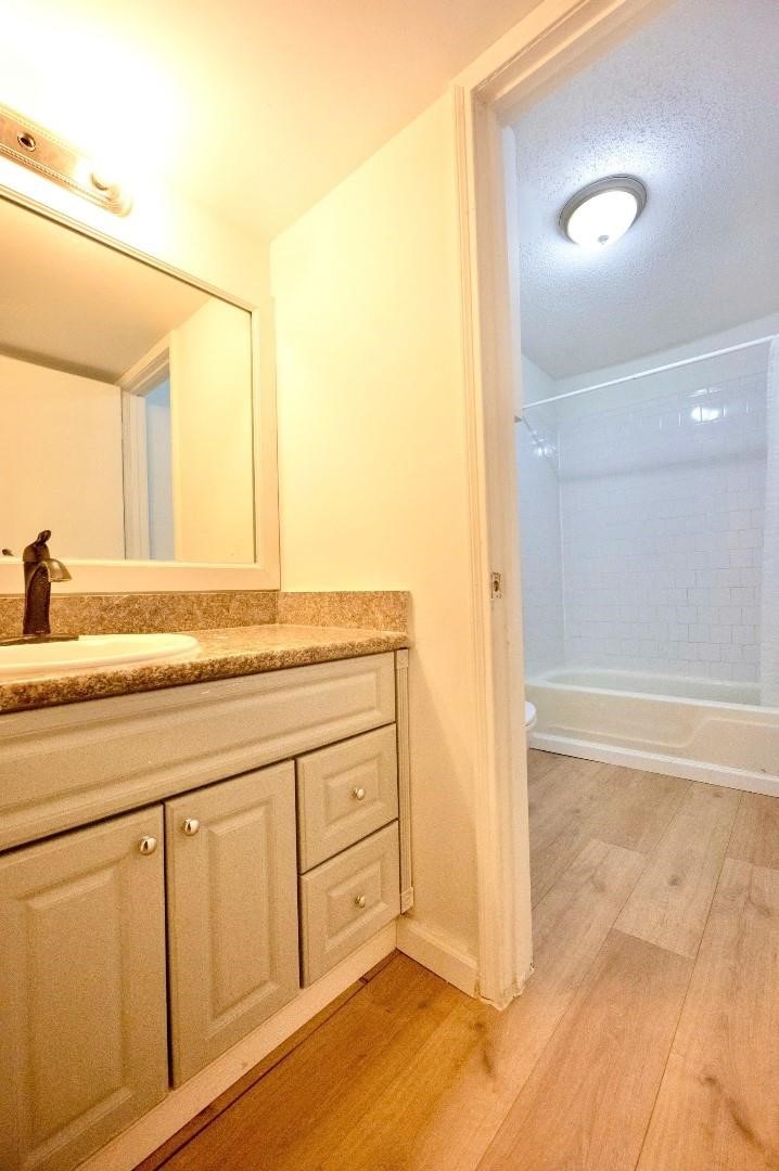 12048 Beechnut Street Houston, TX 77072 - Photo 8 of 13 a bathroom with a granite countertop sink and a mirror