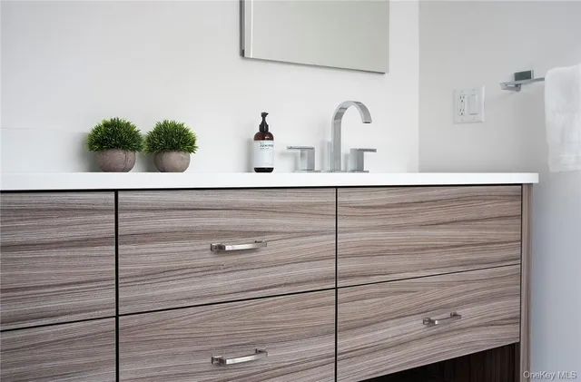 a bathroom with a sink and potted plant