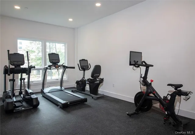 a room with gym equipment and windows