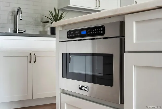a close view of a stove in a white cabinet
