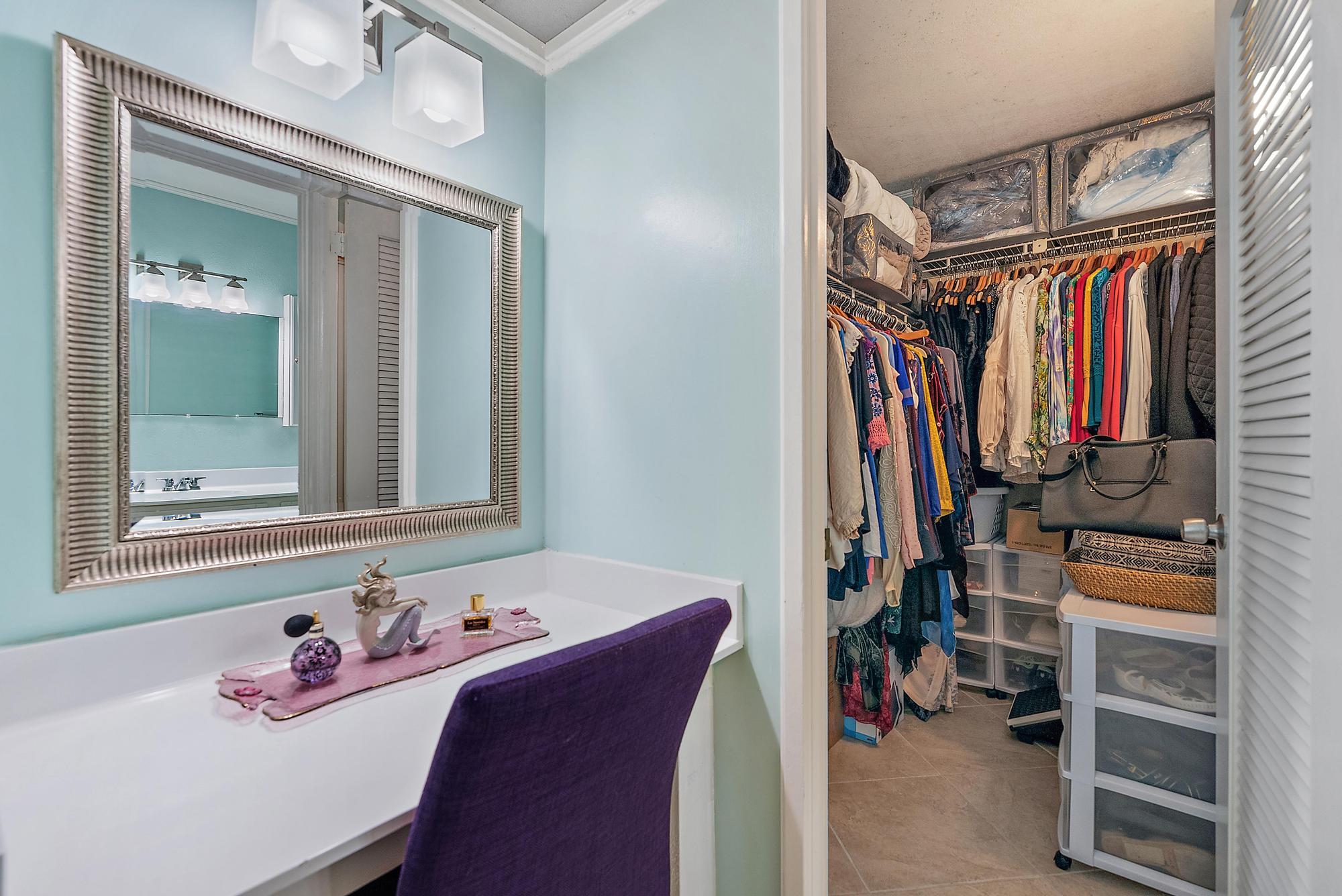 1561 Northeast 12th Terrace, Unit C14 Jensen Beach, FL 34957 - Photo 13 of 38 a view of walk in closet with clothes and shoes