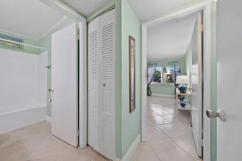 a bathroom with a glass door shower a mirror and a sink