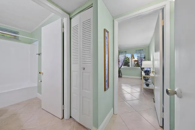 a bathroom with a glass door shower a mirror and a sink