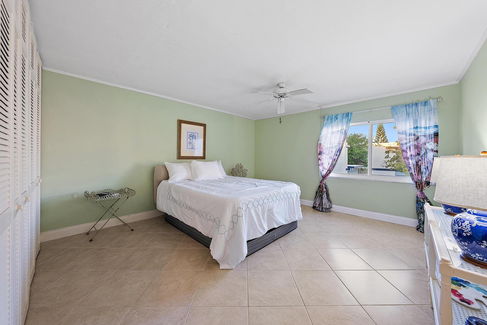 1561 Northeast 12th Terrace, Unit C14 Jensen Beach, FL 34957 - Photo 16 of 38 a bedroom with a bed and a window