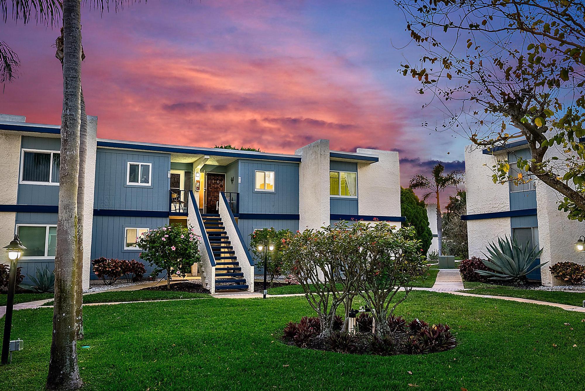 1561 Northeast 12th Terrace, Unit C14 Jensen Beach, FL 34957 - Photo 22 of 38 a front view of a house with a garden