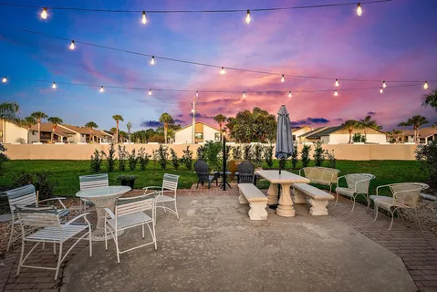 a view of a patio with a table and chairs