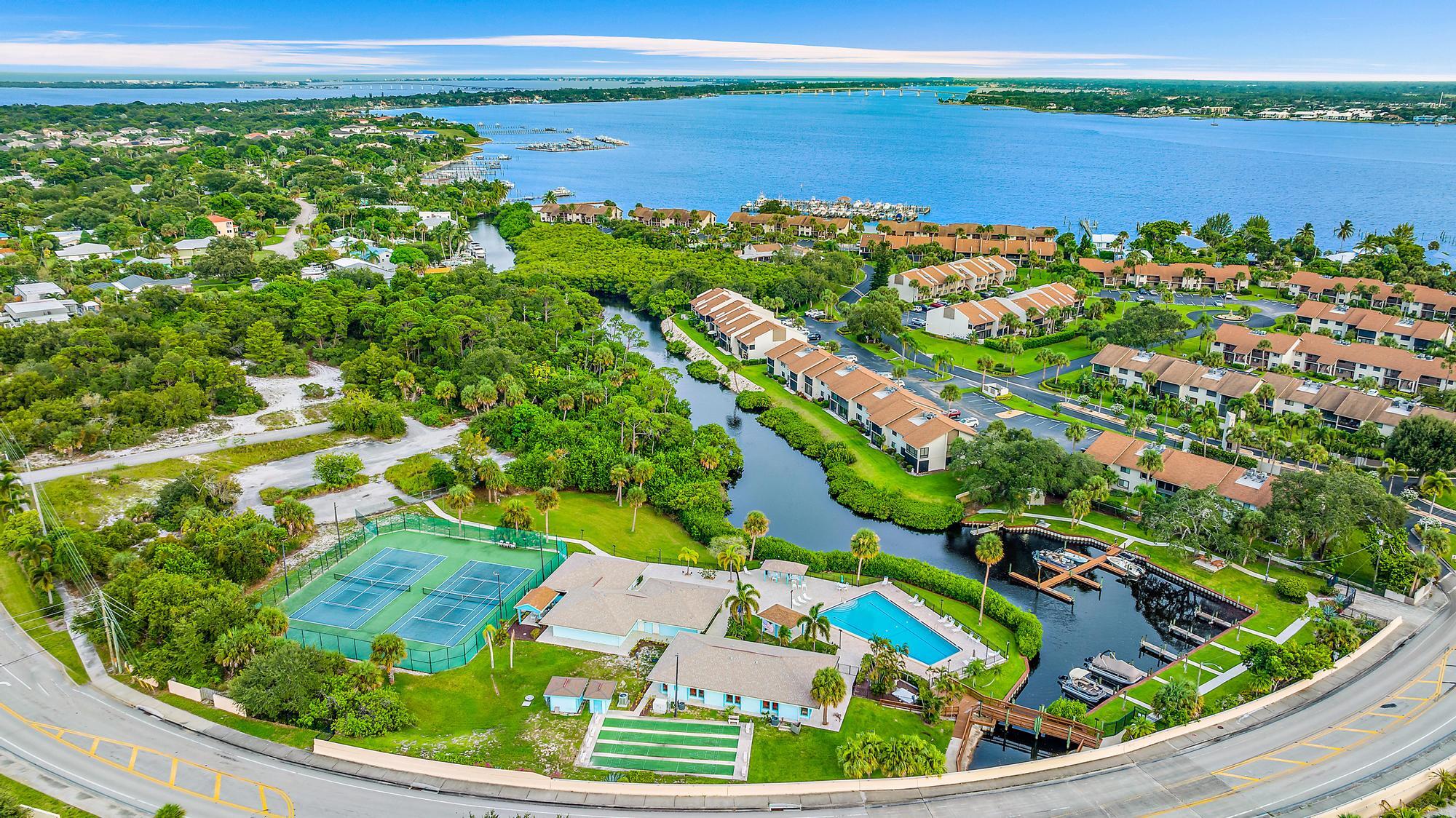 1561 Northeast 12th Terrace, Unit C14 Jensen Beach, FL 34957 - Photo 33 of 38 a view of a garden with a lake