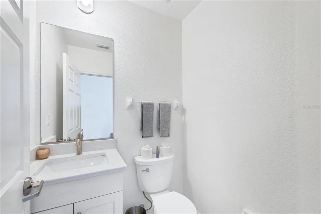 2770 North Beach Road, Unit 303 Englewood, FL 34223 - Photo 16 of 47 a bathroom with a toilet sink and mirror