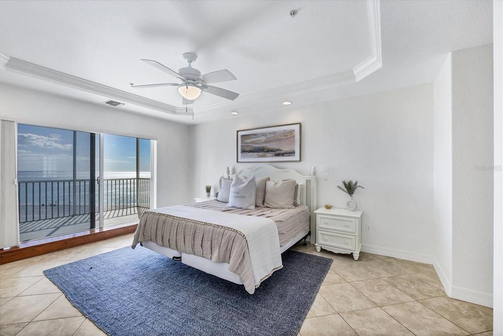 2770 North Beach Road, Unit 303 Englewood, FL 34223 - Photo 17 of 47 a bedroom with a bed and a chandelier