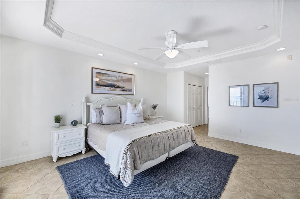 2770 North Beach Road, Unit 303 Englewood, FL 34223 - Photo 19 of 47 a bedroom with a large bed and a chandelier