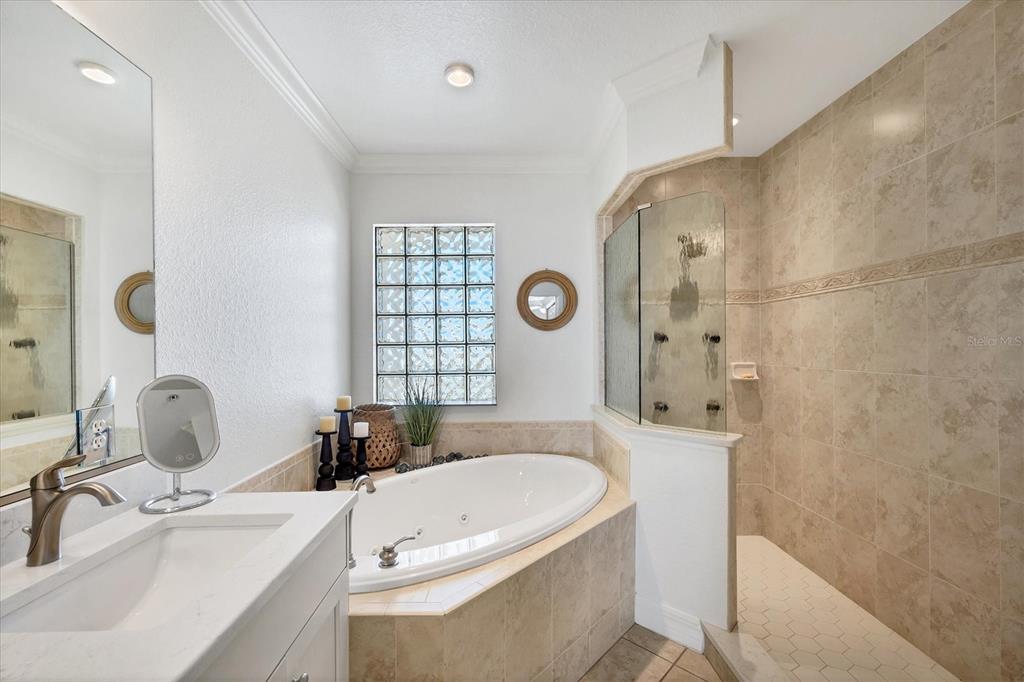 2770 North Beach Road, Unit 303 Englewood, FL 34223 - Photo 21 of 47 a bathroom with a tub sink and mirror