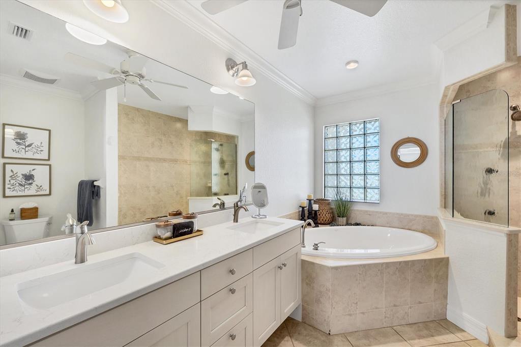 2770 North Beach Road, Unit 303 Englewood, FL 34223 - Photo 22 of 47 a bathroom with double vanity sinks a mirror and a bathtub