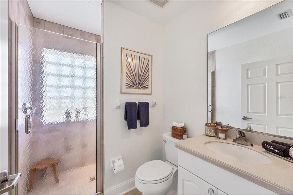 2770 North Beach Road, Unit 303 Englewood, FL 34223 - Photo 26 of 47 a bathroom with a sink a toilet and shower