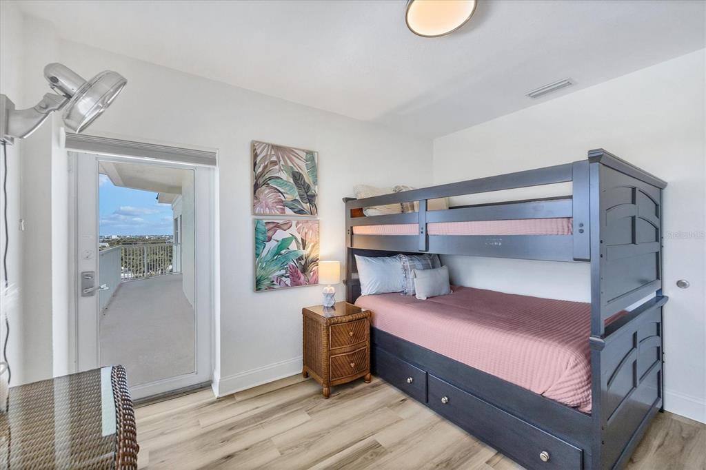 2770 North Beach Road, Unit 303 Englewood, FL 34223 - Photo 27 of 47 a bedroom with a bed and a chandelier