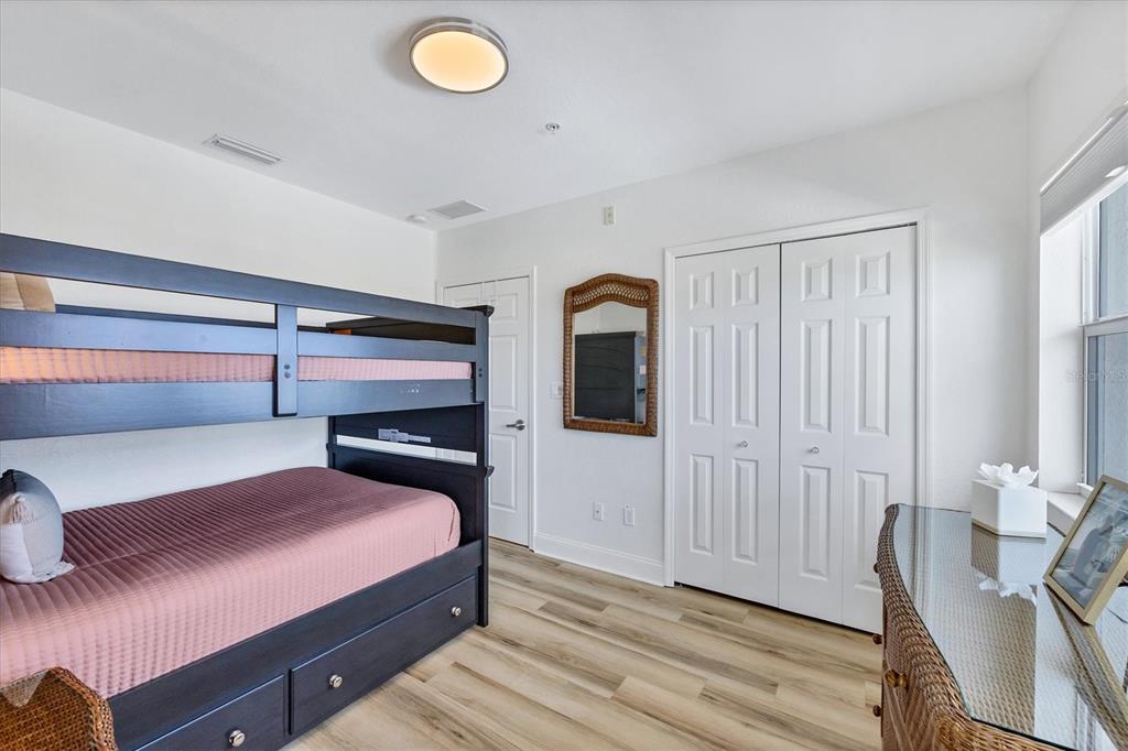 2770 North Beach Road, Unit 303 Englewood, FL 34223 - Photo 28 of 47 a bedroom with a bed and a potted plant