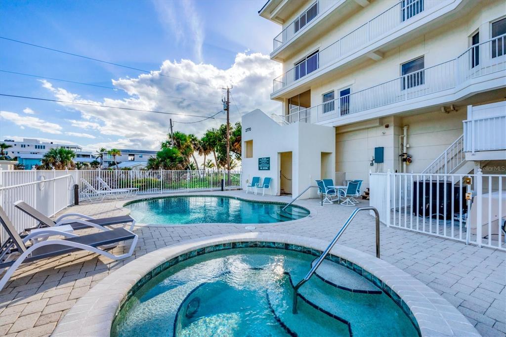 2770 North Beach Road, Unit 303 Englewood, FL 34223 - Photo 30 of 47 a view of a swimming pool with a lounge chairs