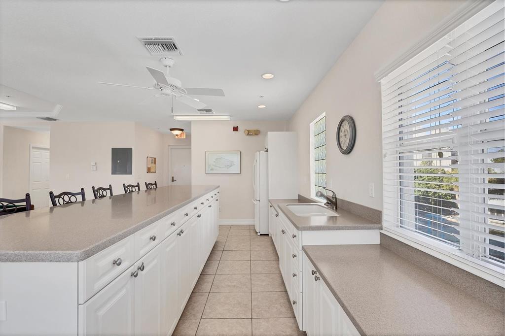 2770 North Beach Road, Unit 303 Englewood, FL 34223 - Photo 35 of 47 a large white kitchen with a large window