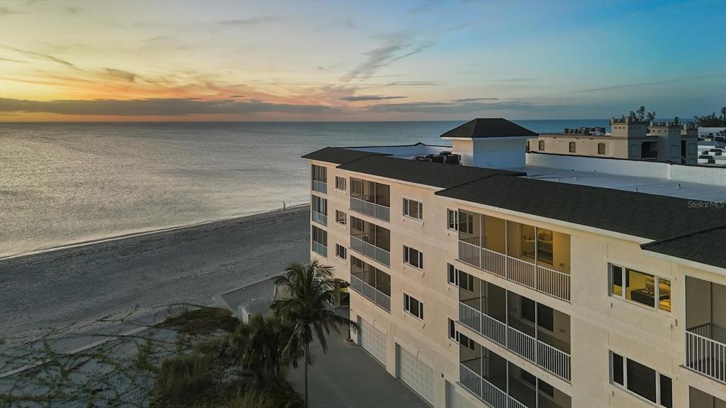 2770 North Beach Road, Unit 303 Englewood, FL 34223 - Photo 46 of 47 a view of building with an outdoor space