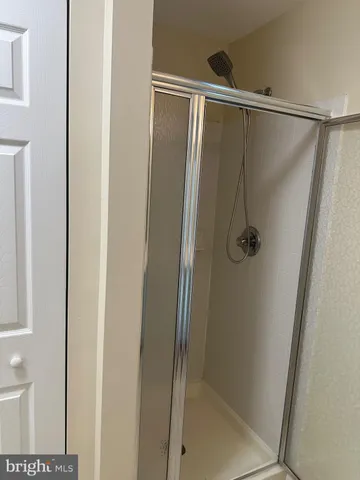 a bathroom with a glass shower door