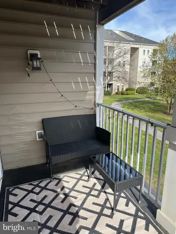 a view of a chairs and table in the balcony