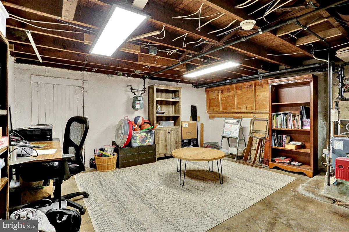 325 2nd Street Reading, PA 19607 - Photo 16 of 38 a bed room with a bed and a stool