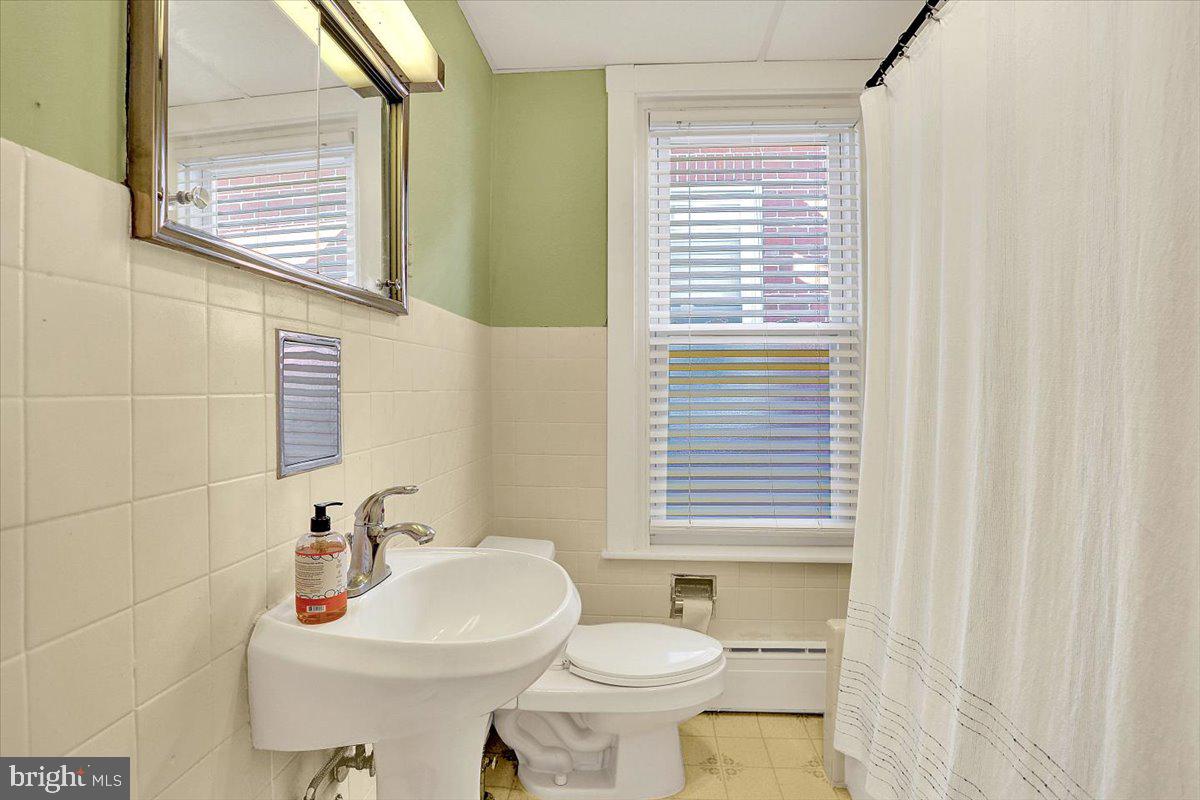 325 2nd Street Reading, PA 19607 - Photo 32 of 38 a bathroom with a sink a toilet and a mirror
