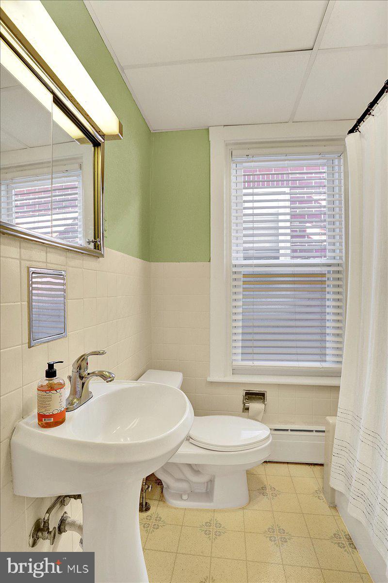 325 2nd Street Reading, PA 19607 - Photo 33 of 38 a bathroom with a sink a toilet and mirror