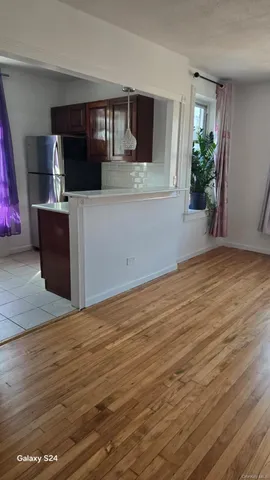 a view of a kitchen and an empty room