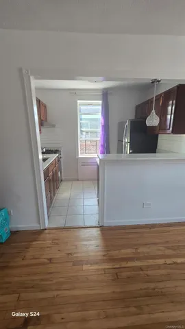 a view of a room with wooden floor