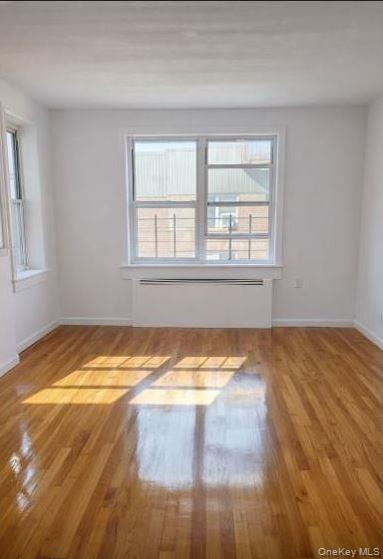 33-16 82nd Street, Unit 6D Queens, NY 11372 - Photo 3 of 16 Spare room featuring light wood finished floors and plenty of natural light