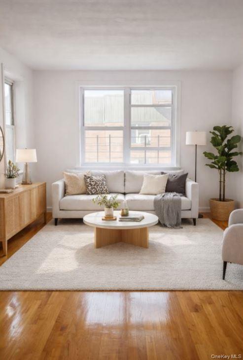 33-16 82nd Street, Unit 6D Queens, NY 11372 - Photo 4 of 16 Living room featuring plenty of natural light and wood finished floors