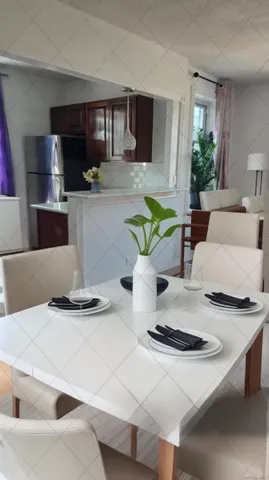 a living room with kitchen island furniture and a wooden floor