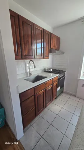 a kitchen with stainless steel appliances granite countertop a sink stove and cabinets