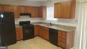 a kitchen with a sink and a refrigerator