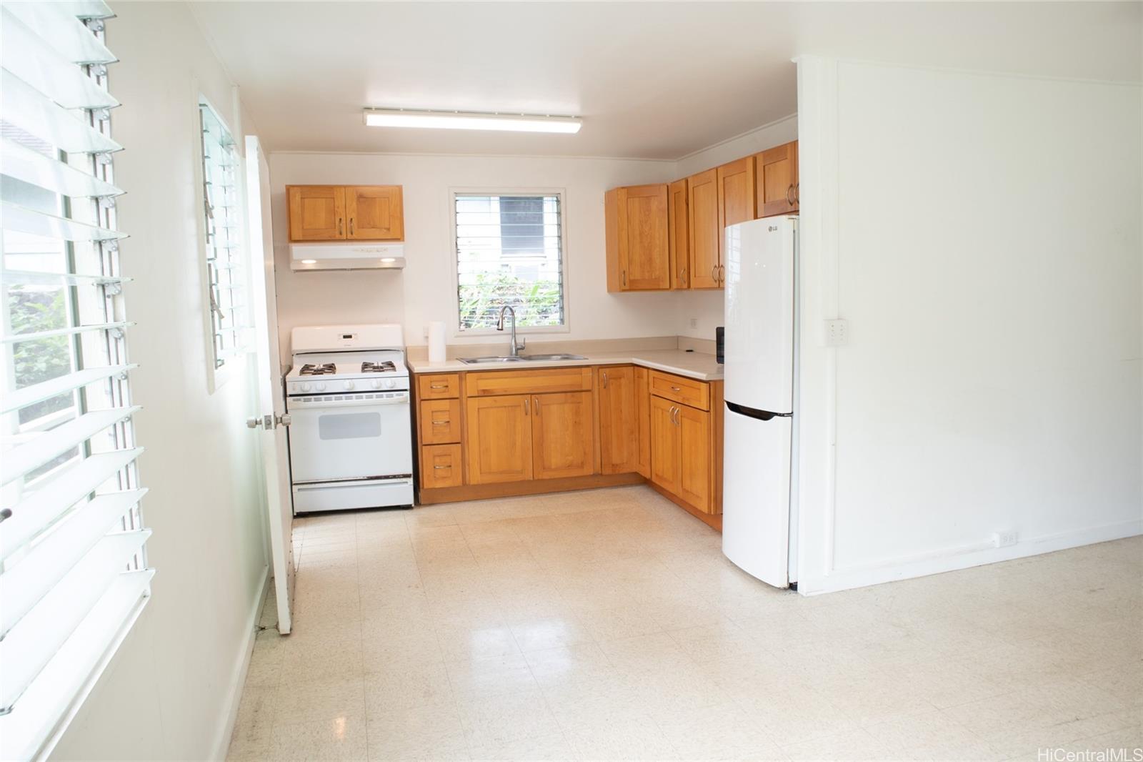 2024 Ohai Lane, Unit D Honolulu, HI 96813 - Photo 6 of 11 a kitchen with stainless steel appliances a refrigerator sink and cabinets