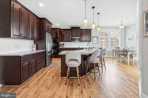 a kitchen with granite countertop a refrigerator and a sink