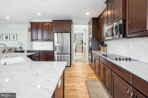 a kitchen with stainless steel appliances granite countertop a refrigerator sink and cabinets
