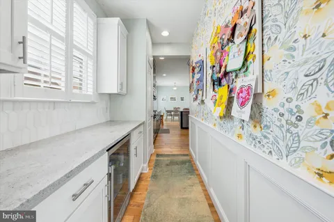 a kitchen with stainless steel appliances granite countertop a kitchen island a stove a table and chairs in it