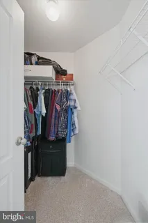 a bathroom with a granite countertop toilet sink and mirror