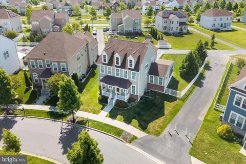 an aerial view of residential houses with outdoor space and swimming pool