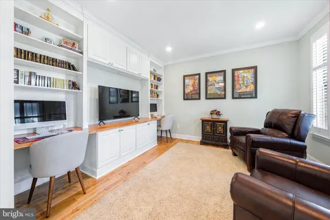 a living room with furniture flat screen tv and a fireplace