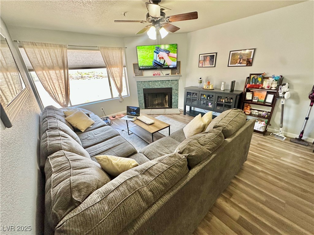 2016 Mesquite Lane, Unit 302 Laughlin, NV 89029 - Photo 2 of 27 Living area with ceiling fan, wood finished floors, baseboards, and a fireplace