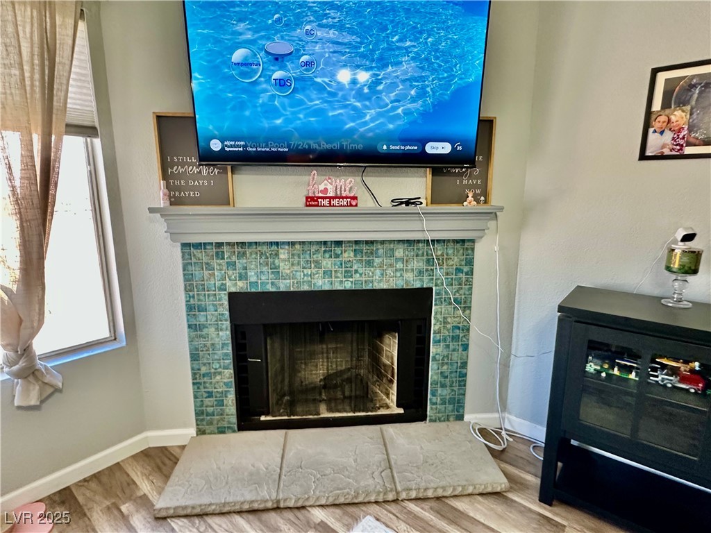 2016 Mesquite Lane, Unit 302 Laughlin, NV 89029 - Photo 5 of 27 Detailed view of wood finished floors, a fireplace, and baseboards