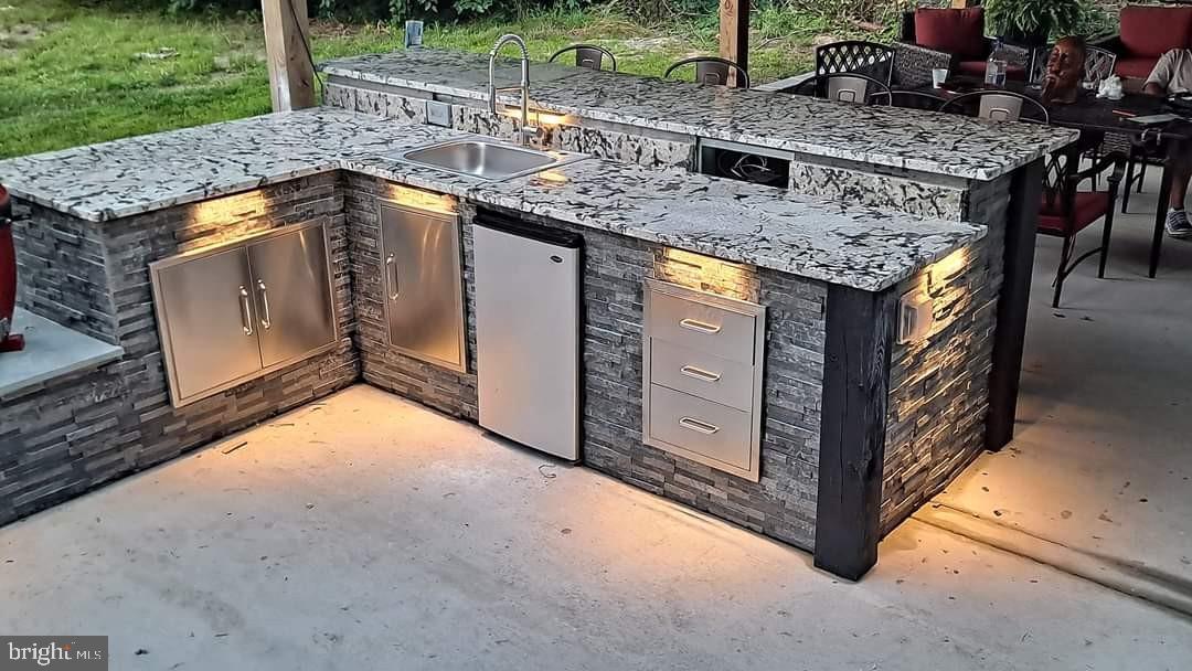 17510 Madrillon Way Accokeek, MD 20607 - Photo 32 of 40 Beautiful stone outdoor kitchen bar