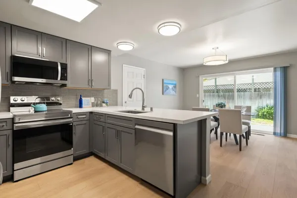 a kitchen with a sink stove and microwave