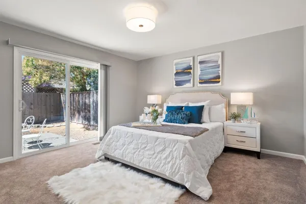 a bedroom with a bed and large window